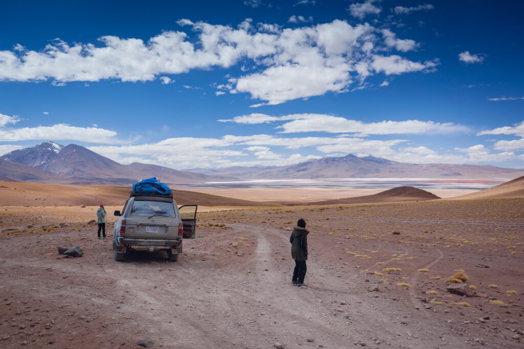 Two people stop to contemplate the views of the Laguna Colorada, in Bolivia.